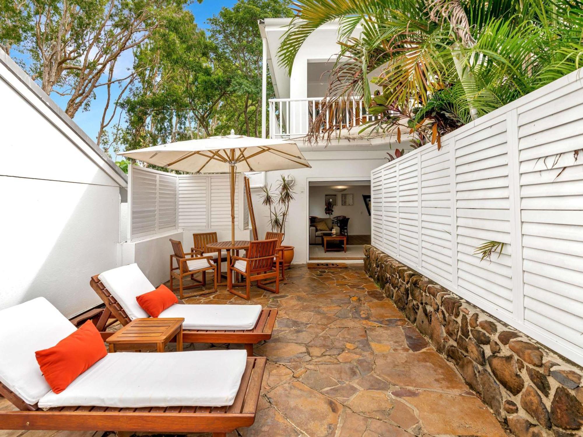 Two-Bedroom and One-Bathroom Apartment with Tropical Garden Patio, Spacious Living and SPA Bath