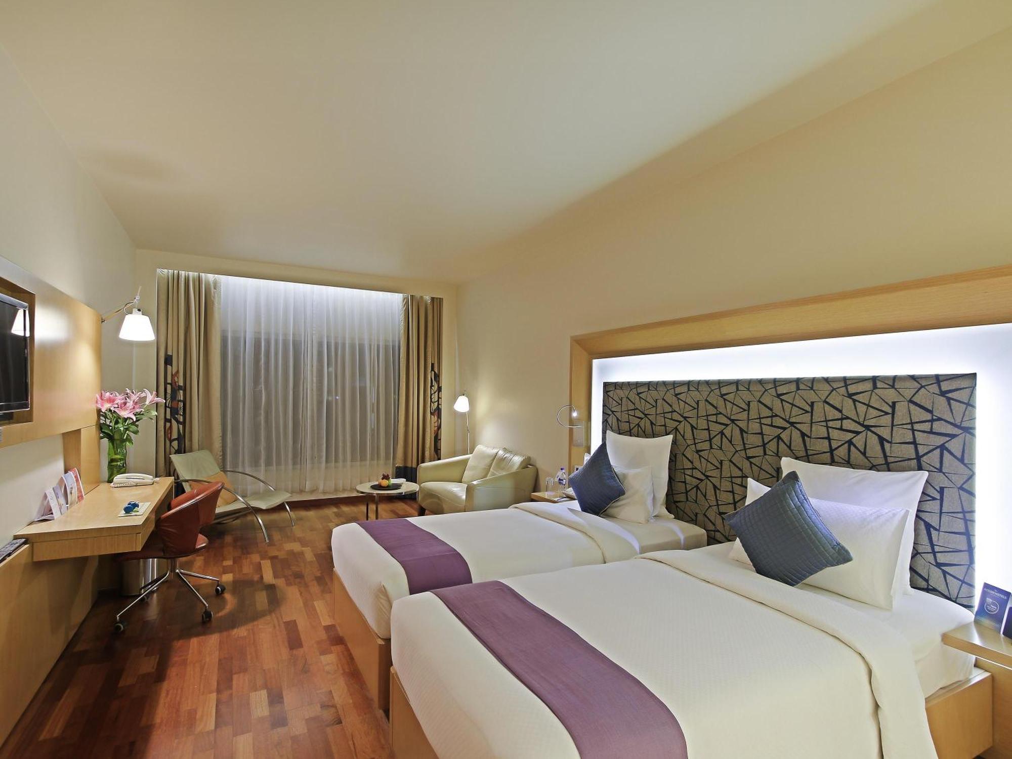 Premier Room with 2 single beds with Premier Lounge Access along with 2 Pieces of Laundry per room per night on non-cumulative basis.
