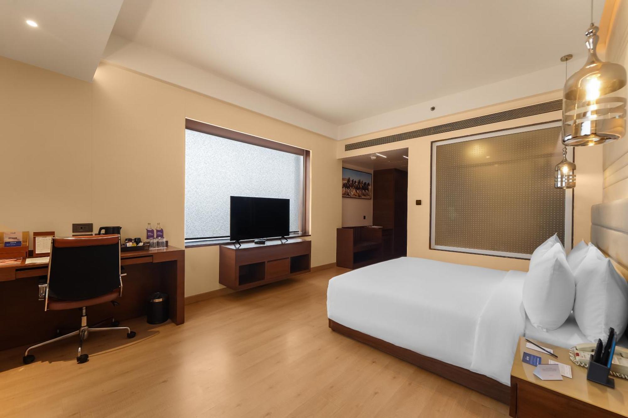 Deluxe Room - INR 500 Hotel Credit redeemable on Food & Soft Bev (min spend of Inr 1000 - Applicable one during stay), Enjoy Happy Hours with 1+1 offer, 20% off on One-way Airport/Railway/Bus Transfer